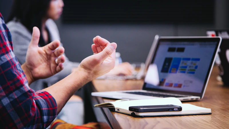 A founder working through an idea across a meeting table.